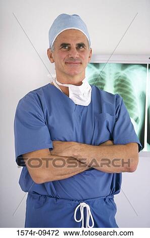 Portrait of a male doctor with his hands folded View Large Photo Image Stock Image - Portrait of a male doctor with his hands folded. Fotosearch