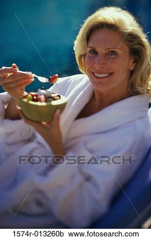 Portrait of a mature woman holding a bowl of fruit salad View Large Photo Image Stock Image - Portrait of a mature woman holding a bowl of fruit salad. Fotosearch