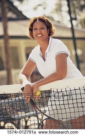 Portrait of a mature woman leaning against a tennis net View Large Photo Image Stock Image - Portrait of a mature woman leaning against a tennis net. Fotosearch