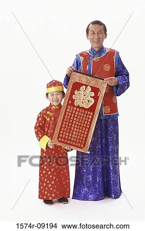 Portrait of a mid adult man holding a poster with his son View Large Photo Image Picture - Portrait of a mid adult man holding a poster with his son. Fotosearch