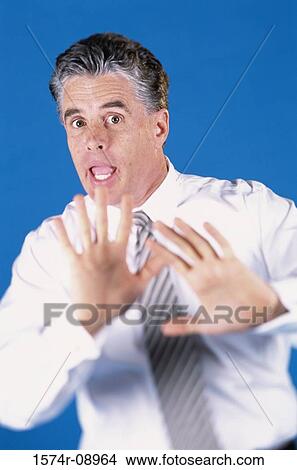 Portrait of a mid adult man with his hands raised View Large Photo Image Picture - Portrait of a mid adult man with his hands raised. Fotosearch