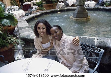Portrait of a mother and daughter smiling in a restaurant View Large Photo Image Stock Image - Portrait of a mother and daughter smiling in a restaurant. Fotosearch