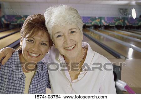 Picture - Portrait of a mother and her daughter holding each other. Fotosearch