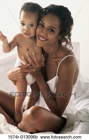 Portrait of a mother holding her son View Large Photo Image Stock Image - Portrait of a mother holding her son. Fotosearch