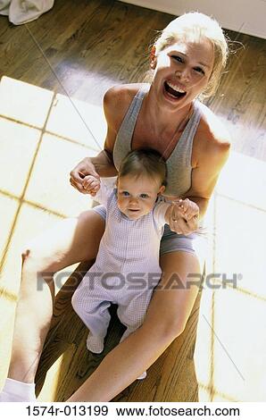 Stock Photo - Portrait of a mother holding her son laughing. Fotosearch