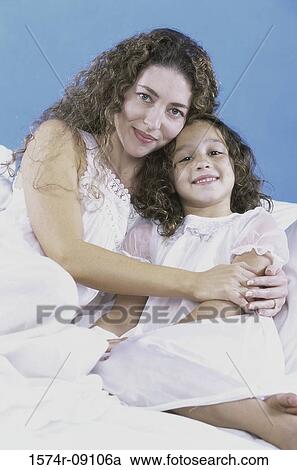 Stock Image - Portrait of a mother holding her daughter. Fotosearch