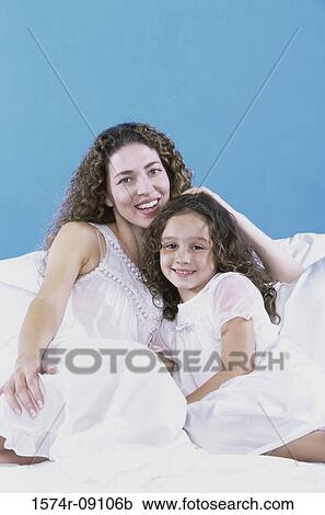Portrait of a mother holding her daughter View Large Photo Image Stock Image - Portrait of a mother holding her daughter. Fotosearch