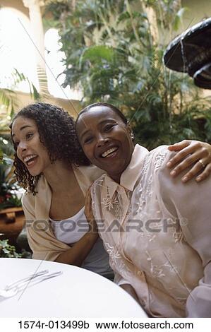 Stock Image - Portrait of a mother sitting with her daughter. Fotosearch