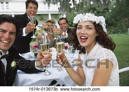 Portrait of a newlywed couple and wedding guests toasting with champagne View Large Photo Image Stock Image - Portrait of a newlywed couple and wedding guests toasting with champagne. Fotosearch