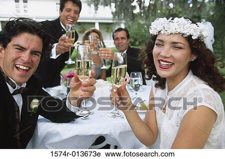 Portrait of a newlywed couple and wedding guests toasting with champagne View Large Photo Image Stock Image - Portrait of a newlywed couple and wedding guests toasting with champagne. Fotosearch