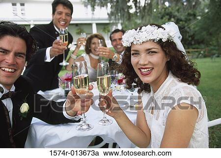 Portrait of a newlywed couple sitting with their parents and wedding guests View Large Photo Image Stock Image - Portrait of a newlywed couple sitting with their parents and wedding guests. Fotosearch
