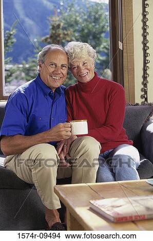 Portrait of a senior couple sitting together on a couch View Large Photo Image Picture - Portrait of a senior couple sitting together on a couch. Fotosearch