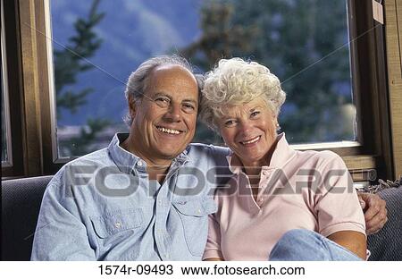 Portrait of a senior couple sitting together on a couch View Large Photo Image Stock Image - Portrait of a senior couple sitting together on a couch. Fotosearch