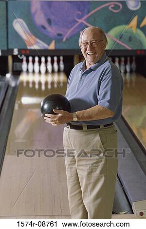 Portrait of a senior man holding a bowling ball View Large Photo Image Stock Image - Portrait of a senior man holding a bowling ball. Fotosearch