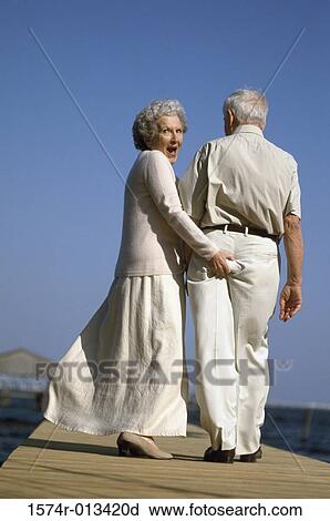 Stock Image - Portrait of a senior woman flirting with a senior man. Fotosearch