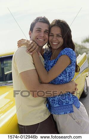 Portrait of a teenage couple embracing each other View Large Photo Image Stock Image - Portrait of a teenage couple embracing each other. Fotosearch