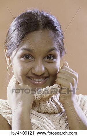 Portrait of a teenage girl hiding her face with her turtleneck View Large Photo Image Stock Image - Portrait of a teenage girl hiding her face with her turtleneck. Fotosearch
