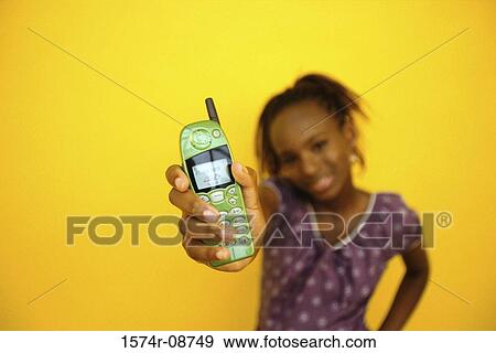 Stock Photo - Portrait of a teenage girl holding a mobile phone. Fotosearch