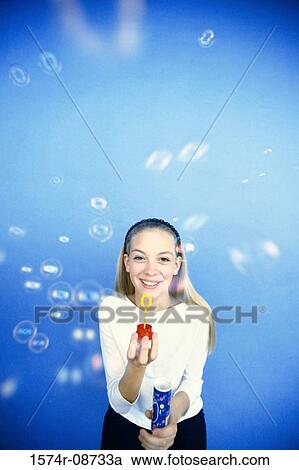 Portrait of a teenage girl playing with a bubble wand View Large Photo Image Stock Image - Portrait of a teenage girl playing with a bubble wand. Fotosearch
