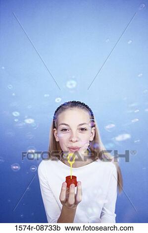 Portrait of a teenage girl playing with a bubble wand View Large Photo Image Stock Image - Portrait of a teenage girl playing with a bubble wand. Fotosearch