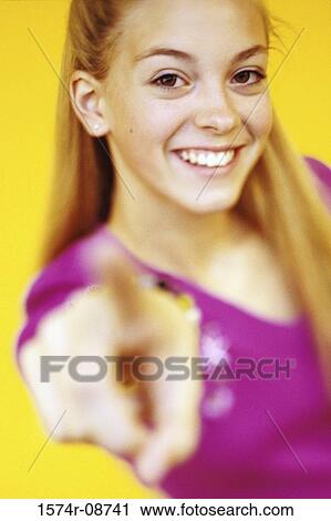 Portrait of a teenage girl pointing forward View Large Photo Image Stock Image - Portrait of a teenage girl pointing forward. Fotosearch