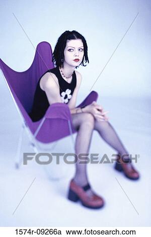 Portrait of a teenage girl sitting on a chair View Large Photo Image Stock Image - Portrait of a teenage girl sitting on a chair. Fotosearch