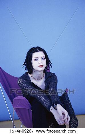 Portrait of a teenage girl sitting on a chair View Large Photo Image Stock Photo - Portrait of a teenage girl sitting on a chair. Fotosearch