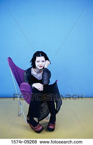 Portrait of a teenage girl sitting on a chair View Large Photo Image Stock Photo - Portrait of a teenage girl sitting on a chair. Fotosearch