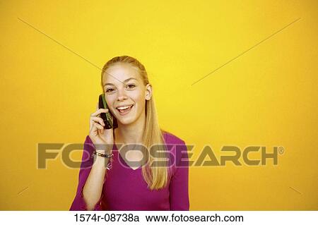 Stock Image - Portrait of a teenage girl talking on a mobile phone. Fotosearch