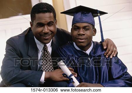 Portrait of a teenage graduate sitting with his father View Large Photo Image Stock Photograph - Portrait of a teenage graduate sitting with his father. Fotosearch