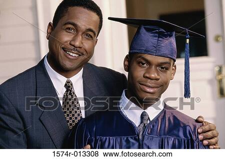 Portrait of a teenage graduate with his father smiling View Large Photo Image Stock Photo - Portrait of a teenage graduate with his father smiling. Fotosearch