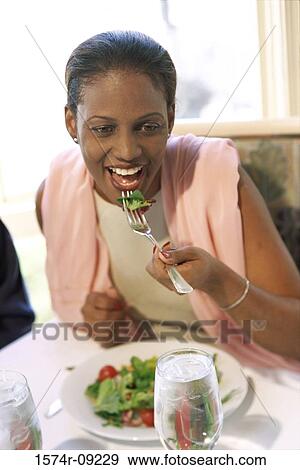 Portrait of a woman eating a bowl of salad View Large Photo Image Stock Photo - Portrait of a woman eating a bowl of salad. Fotosearch