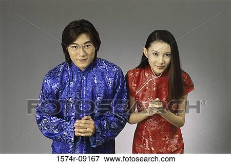 Stock Photo - Portrait of a young couple bowing. Fotosearch
