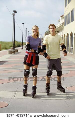 Portrait of a young couple inline skating View Large Photo Image Stock Image - Portrait of a young couple inline skating. Fotosearch