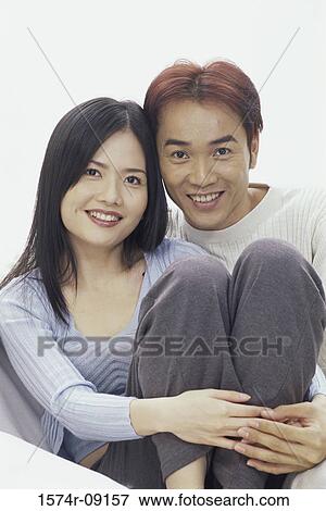 Stock Photo - Portrait of a young couple smiling. Fotosearch