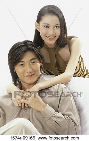 Portrait of a young couple smiling View Large Photo Image Stock Photograph - Portrait of a young couple smiling. Fotosearch