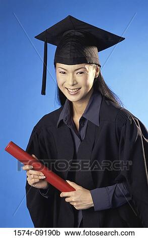 Portrait of a young female graduate holding a diploma View Large Photo Image Stock Image - Portrait of a young female graduate holding a diploma. Fotosearch