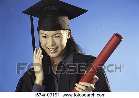 Portrait of a young female graduate holding a diploma View Large Photo Image Stock Image - Portrait of a young female graduate holding a diploma. Fotosearch