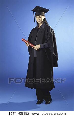 Stock Image - Portrait of a young female graduate holding a diploma. Fotosearch