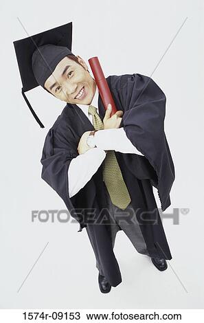 Portrait of a young male graduate holding a diploma View Large Photo Image Stock Image - Portrait of a young male graduate holding a diploma. Fotosearch