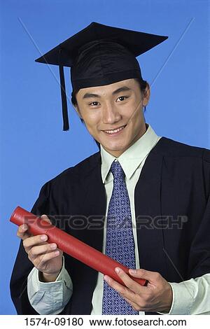 Portrait of a young male graduate holding a diploma View Large Photo Image Stock Image - Portrait of a young male graduate holding a diploma. Fotosearch