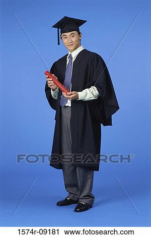 Portrait of a young male graduate holding a diploma View Large Photo Image Stock Image - Portrait of a young male graduate holding a diploma. Fotosearch