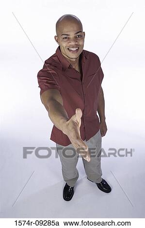Portrait of a young man extending his arm out to shake hands View Large Photo Image Stock Image - Portrait of a young man extending his arm out to shake hands. Fotosearch