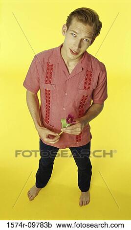 Portrait of a young man holding a single rose View Large Photo Image Stock Image - Portrait of a young man holding a single rose. Fotosearch