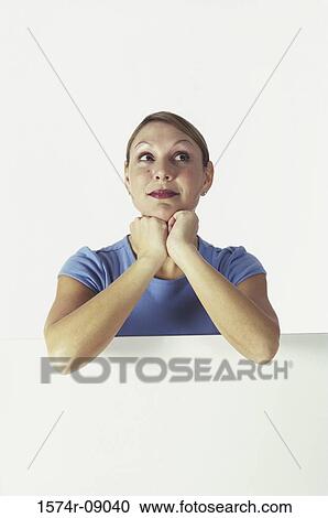 Portrait of a young woman behind a wall View Large Photo Image Stock Image - Portrait of a young woman behind a wall. Fotosearch