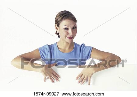 Portrait of a young woman behind a wall View Large Photo Image Stock Photo - Portrait of a young woman behind a wall. Fotosearch