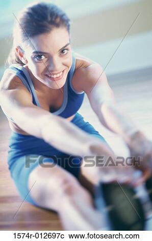 Portrait of a young woman exercising View Large Photo Image Stock Image - Portrait of a young woman exercising. Fotosearch