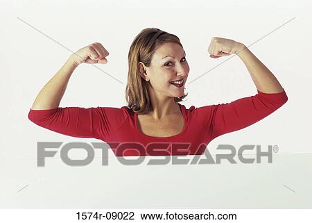 Portrait of a young woman flexing her biceps View Large Photo Image Stock Image - Portrait of a young woman flexing her biceps. Fotosearch