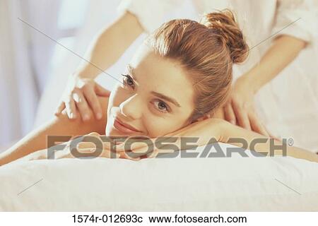Portrait of a young woman getting a back massage View Large Photo Image Stock Image - Portrait of a young woman getting a back massage. Fotosearch