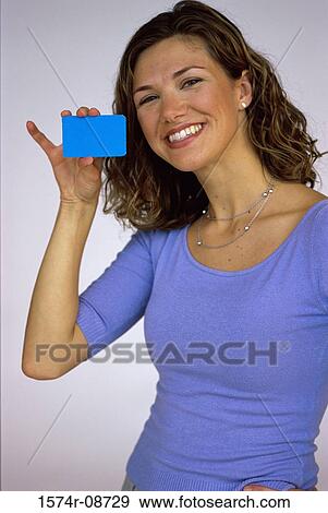 Portrait of a young woman holding out a credit card View Large Photo Image Stock Photo - Portrait of a young woman holding out a credit card. Fotosearch